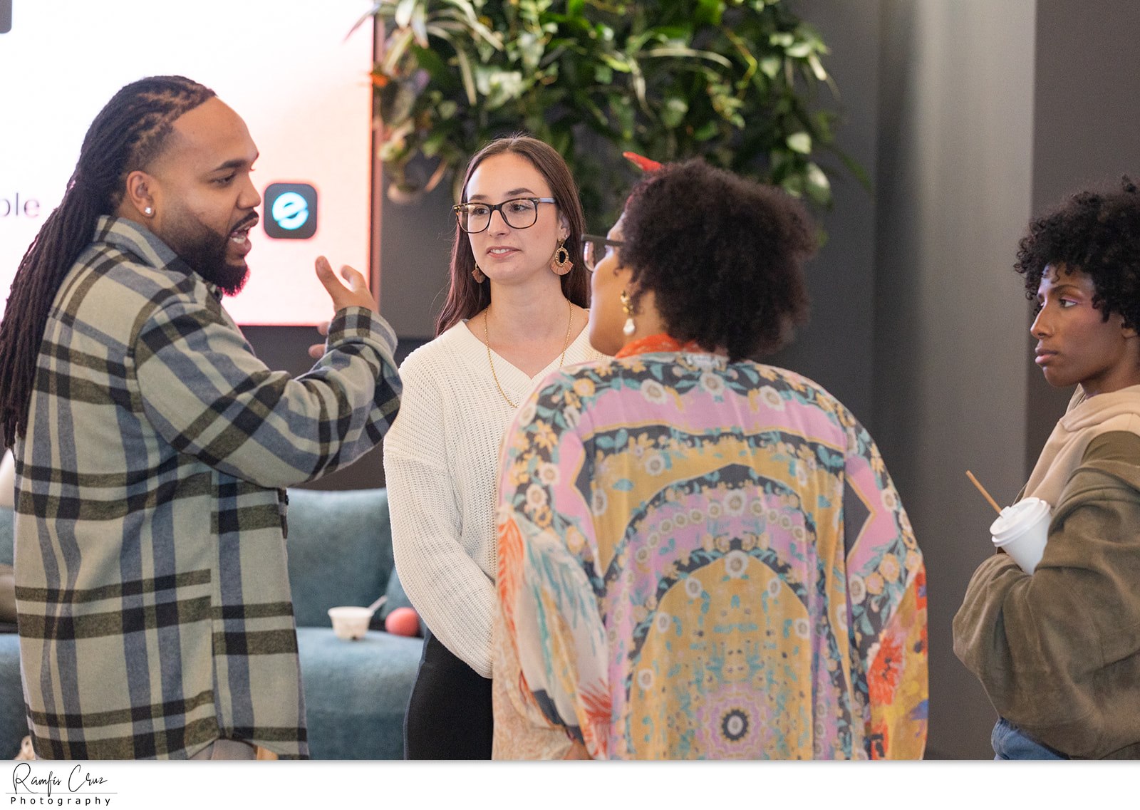 Four attendees deep in conversation during a networking break
